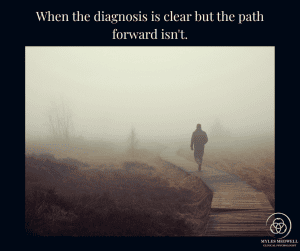 Person walking alone on a foggy boardwalk path with quote "When the diagnosis is clear but the path forward isn't" - Myles Medwell Psychology Richmond Melbourne
